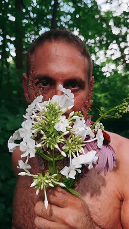 man with flowers in forest