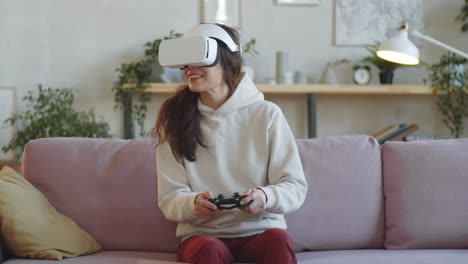 woman in vr glasses playing video game with controller