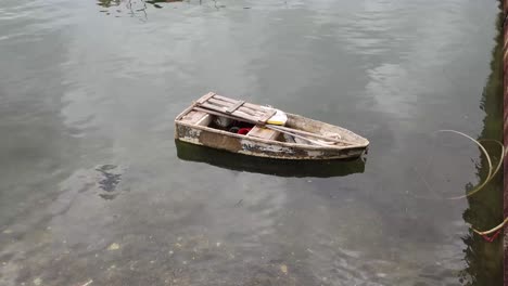 Old-dinghy-drifting-on-the-sea-lonely