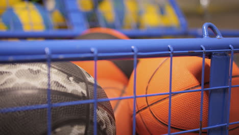 Close-up-descending-shot-of-school-set-of-basketballs,-shallow-focus