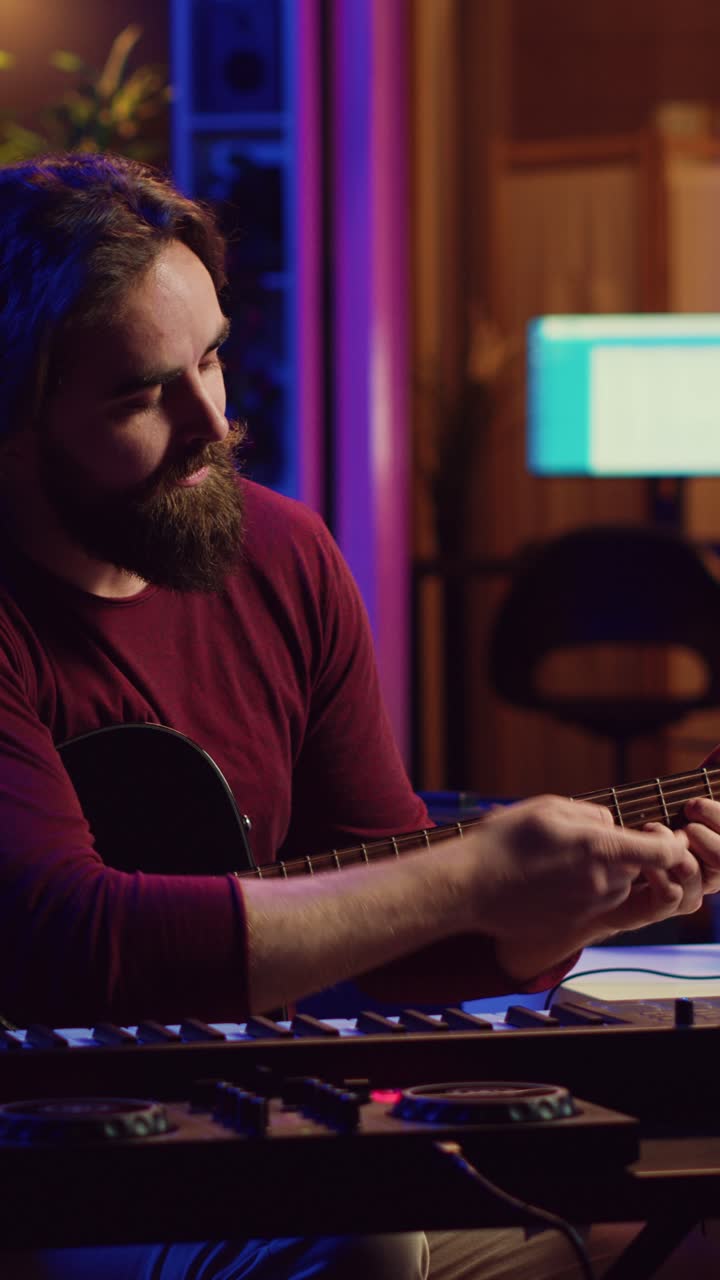 Creative Man Playing Acoustic Guitar in Neon Lit Studio