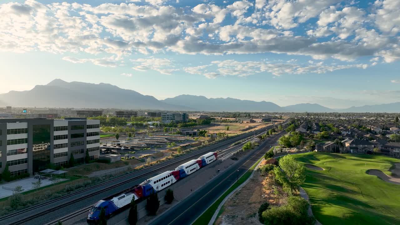 FrontRunner commuter railway operated by the Utah Transit Authority runs along the Wasatch Front - this train is leaving Lehi Station northbound towards Salt Lake City - aerial flyover