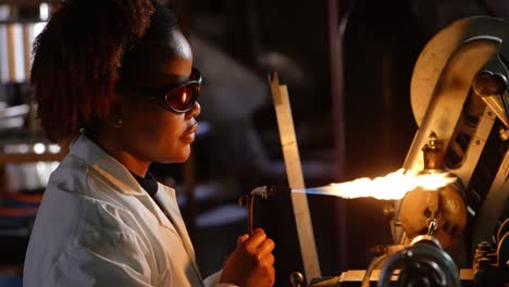 Side-view-of-black-female-worker-creating-glass-in-glass-factory-4k
