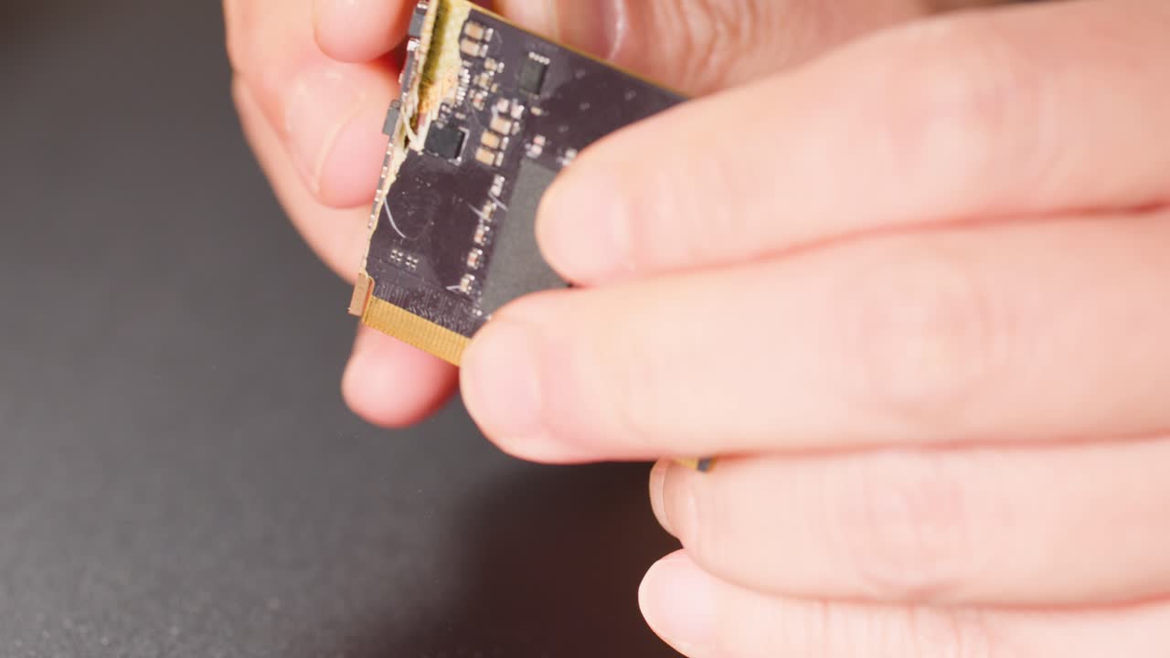 Macro shot of hands demonstrating the durability and flexibility of a modern printed circuit board