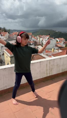 young girl playing drums on a rooftop