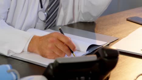 physician working on his desk in clinic 4k