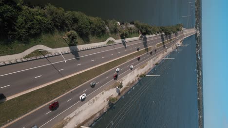 Cinematic-drone-shot-of-coastal-highway-causeway-with-light-traffic---vertical-video