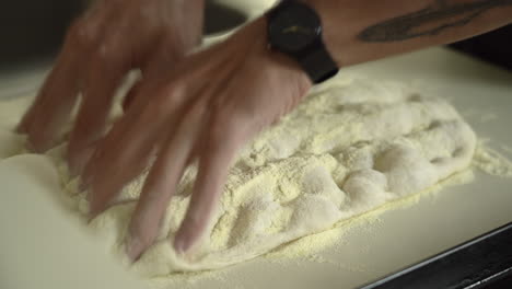 pizzaiolo hand-stretching roman high hydration pizza dough