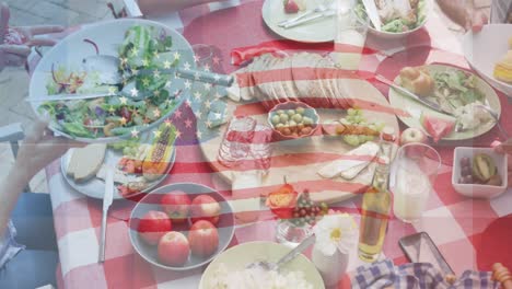 animation of flag of usa waving over table full of food