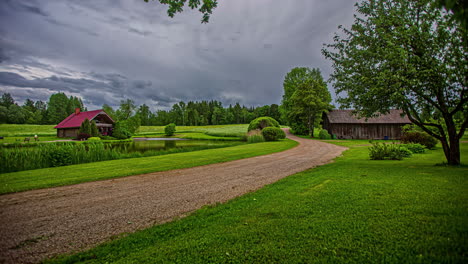 scenic countryside time lapse with two houses and a dramatic, stormy sky