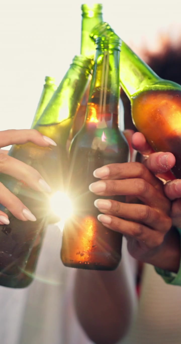 Group of Friends Toasting with Beer Bottles Outdoors