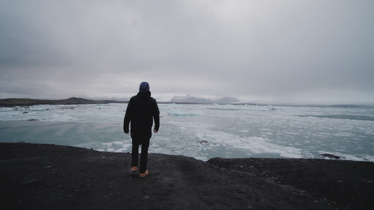 Person Contemplating a Glacier Lake