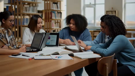 diverse group of students studying and collaborating in a library