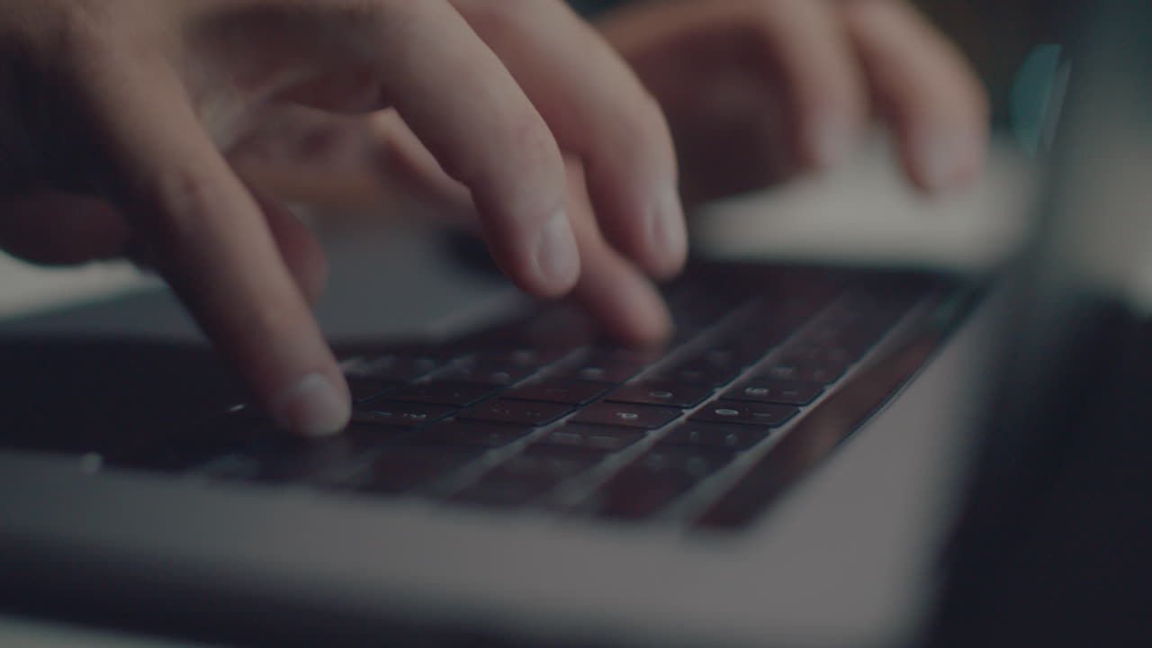 White hands typing text at night