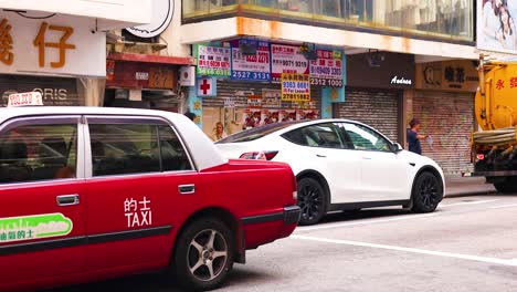 taxis and vehicles navigate a bustling street