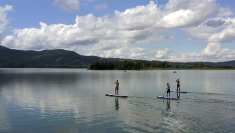 stand-up-paddling on the kochelsee near munich, germany at the edge of the bavarian alps