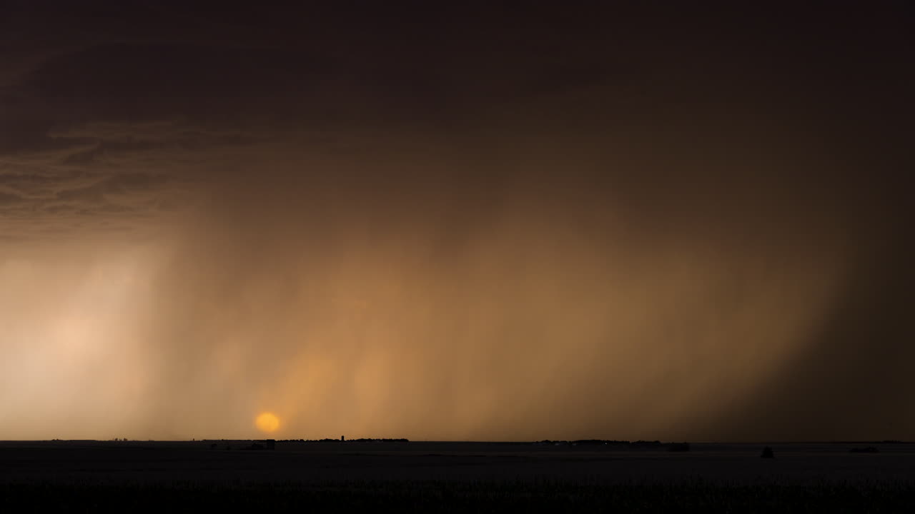 A bright colorful sunset with lightning striking the ground