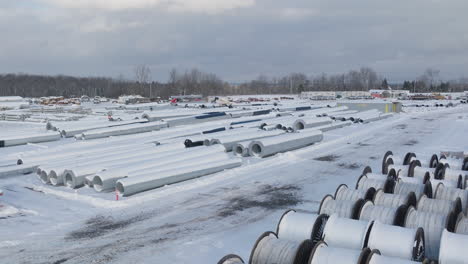 snow covered rural construction supply yard, aerial