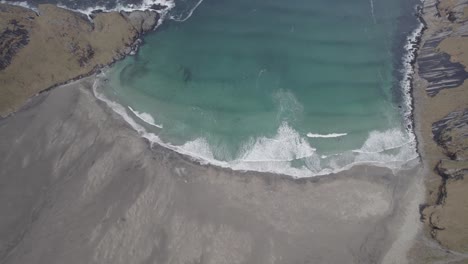 Aerial-view-towards-the-Bunes-beach,-dark,-autumn-day-in-Lofoten,-Norway---tilt,-drone-shot