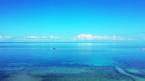 beautiful seascape with turquoise shallow lagoon and endless ocean reflecting white clouds rising on bright sky in philippines