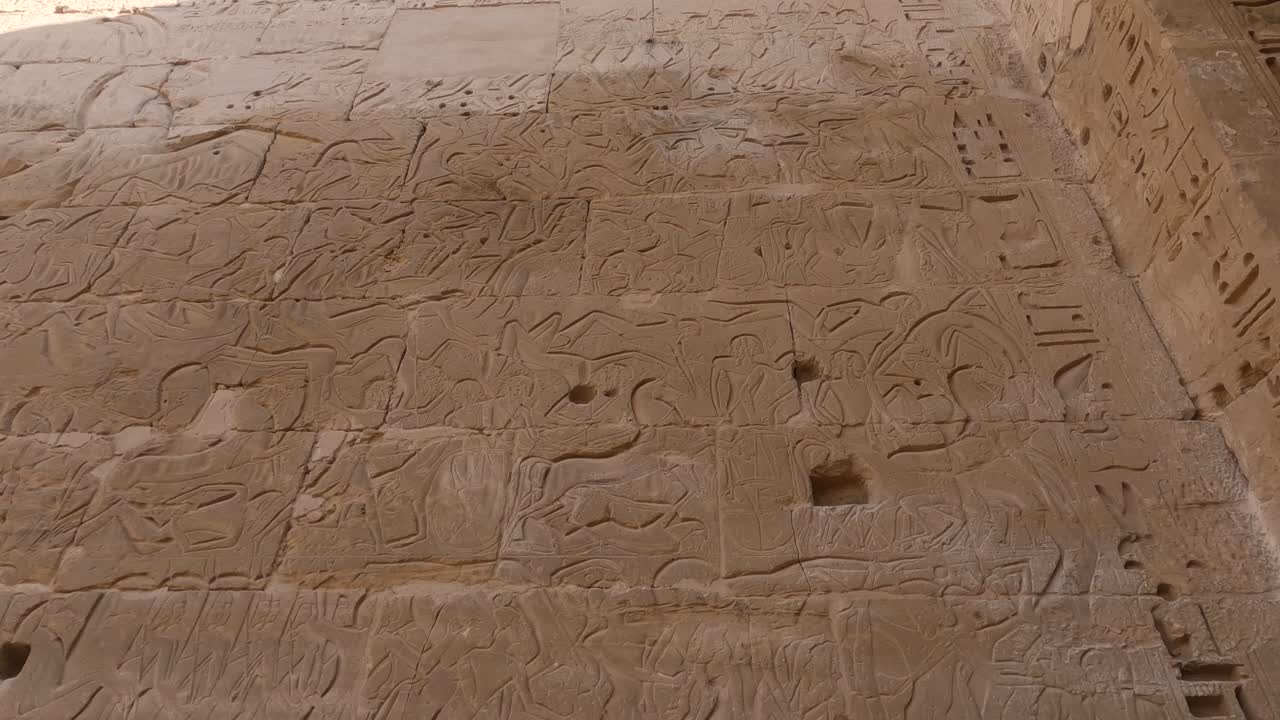 Wall reliefs and ancient Egyptian inscriptions - Medinet Habu, Luxor, Egypt