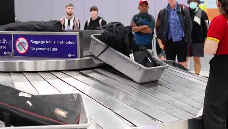 airport baggage carousel with passengers