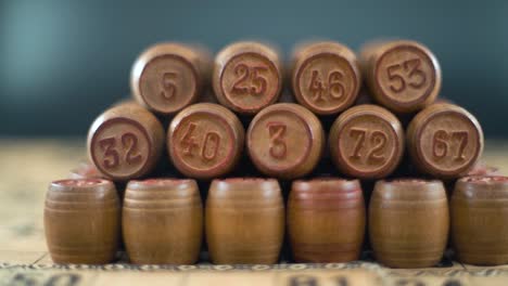 cinematic creative smooth dreamy macro shot of bingo wooden barrels in a row, woody figures, old numbers background, vintage board game, slow motion 120 fps commercial gimbal video, crane slide right