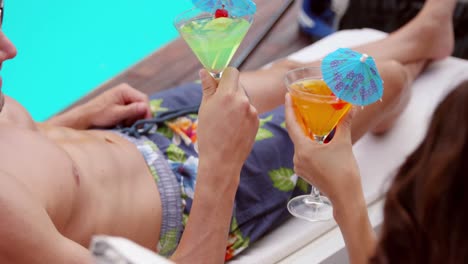 smiling young couple toasting drinks