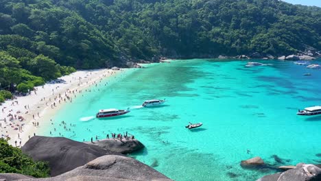 tourists crowding similan islands beach during peak season in phuket, thailand