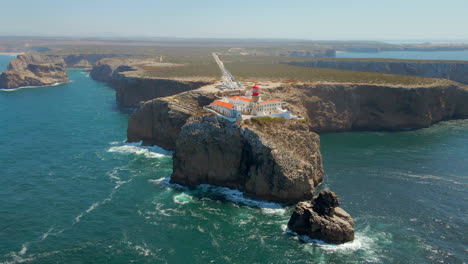 Aerial-view-of-the-Cape-of-Saint-Vicente-lighthouse,-located-on-the-edge-of-the-cliffs-on-the-Vicentine-coast-of-the-Algarve,-Portugal