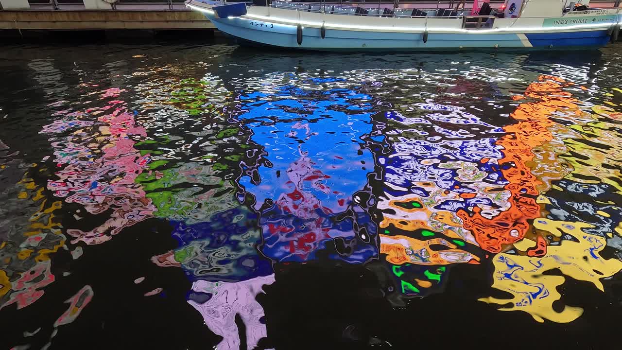 Vibrant billboards and Glico Running Man sign light up the famous Dotonbori district in Osaka, Japan.