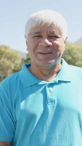 vertical video of portrait of happy senior caucasian man in garden in slow motion