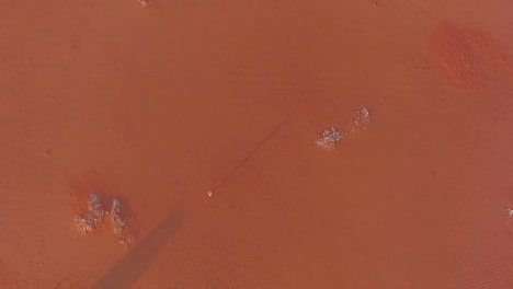 a man walks in the desert from above in riyadh saudi arabia