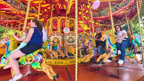 families enjoying a colorful carousel ride