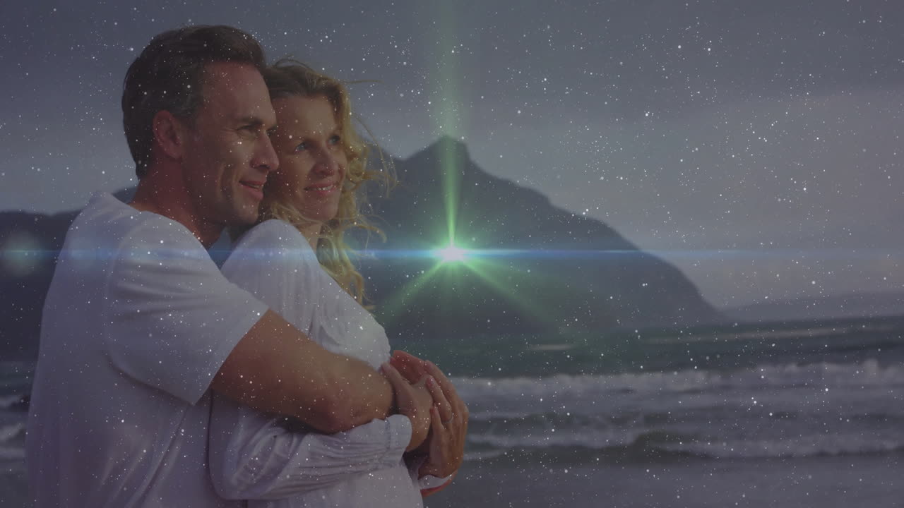 Couple embracing on sandy beach at dusk, showcasing technology with star field and green lens flare