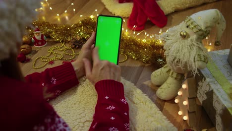 green screen pnone in hands. christmas concept