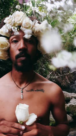 man with a crown of roses in a forest