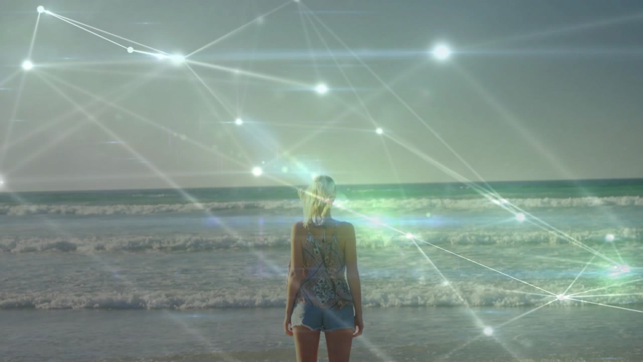 Sunlight flares and digital glow guiding woman standing up on beach as tech network hovering