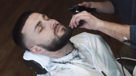 man getting beard trimmed at a barbershop