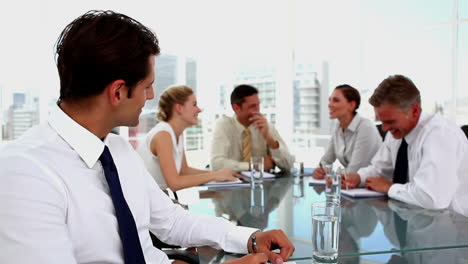 Confident-businessman-looking-at-camera-