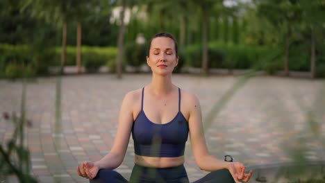 woman meditating in a park