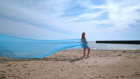 Love-couple-kissing-rolled-in-fabric-at-beach.-Romantic-relationship-concept