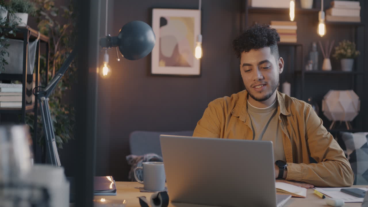 Man working on a laptop in a cozy home office