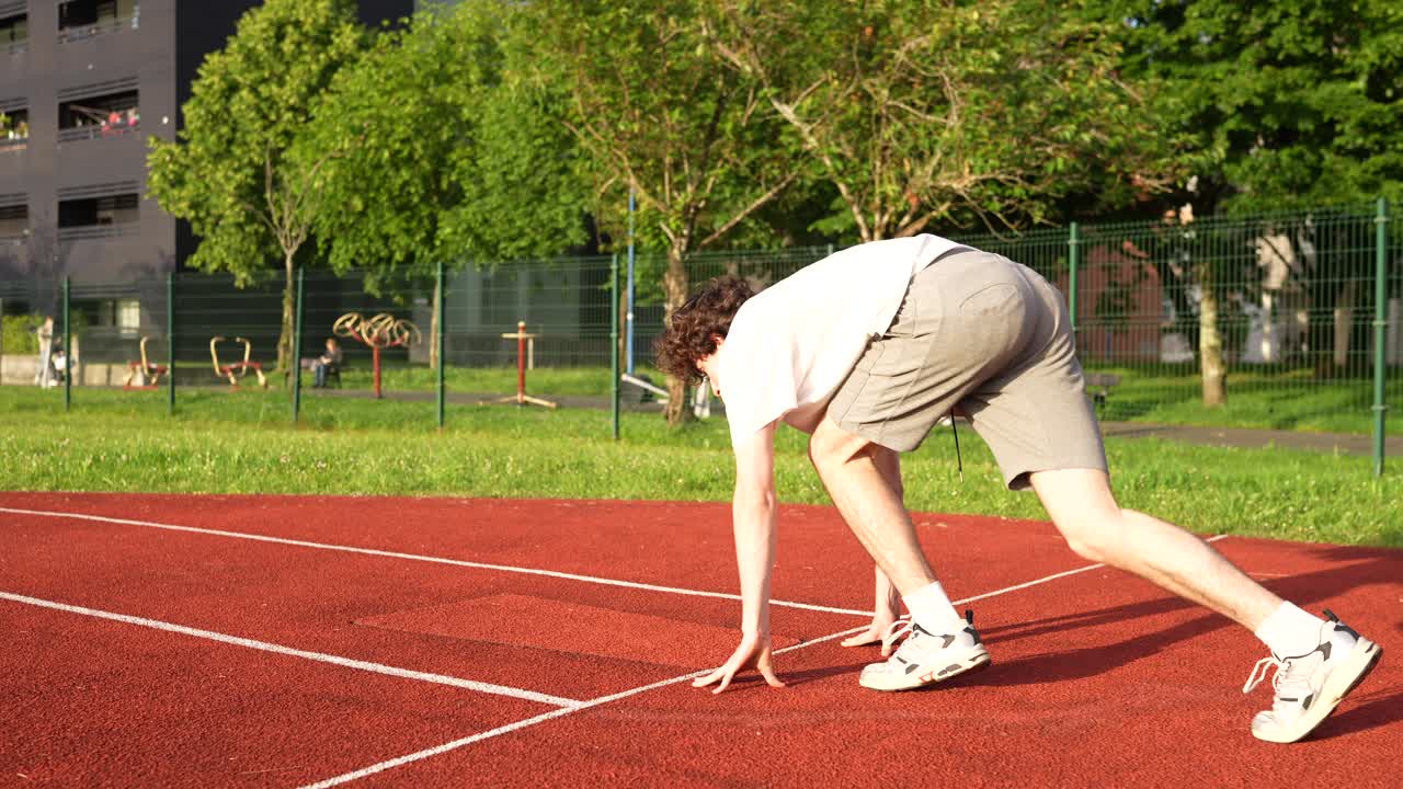 Man exercising on running track
