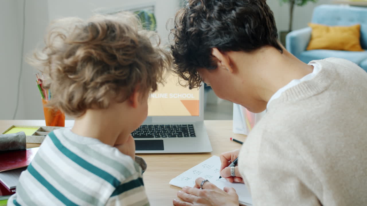 Mother helping child with online school homework