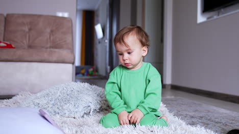 baby sitting on a fluffy carpet