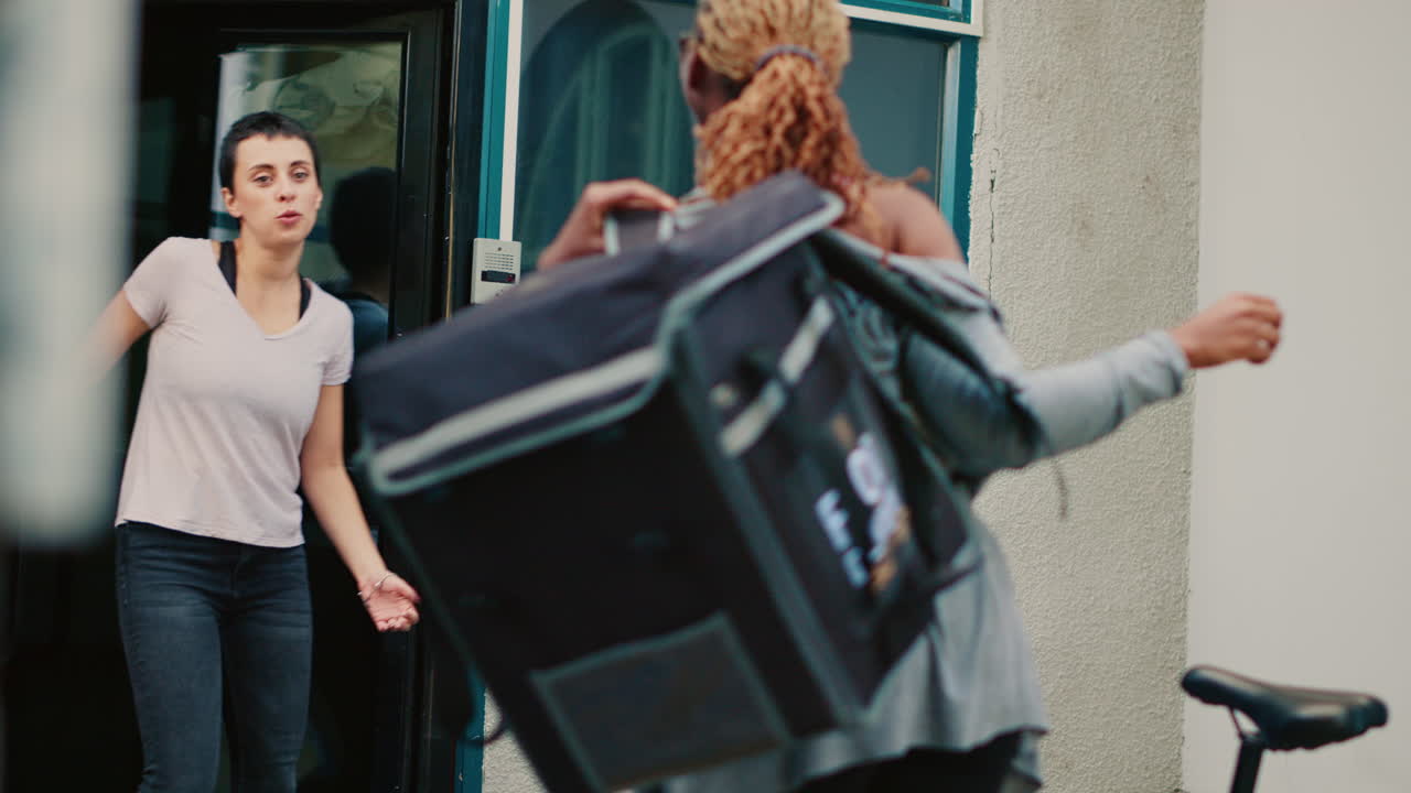 A food delivery person delivers food to a customer