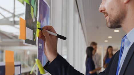 businessman writing notes at a business conference