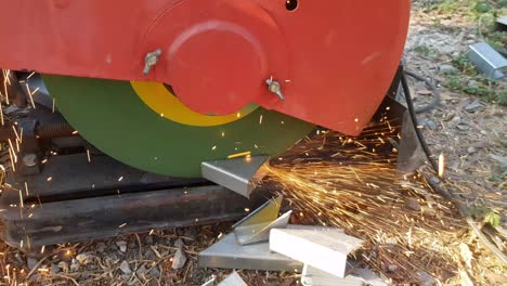 construction workers cut steel with a circular saw. make a spark