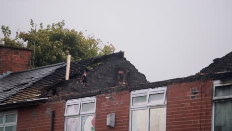 fire damaged home in blackburn, uk with roof collapsed